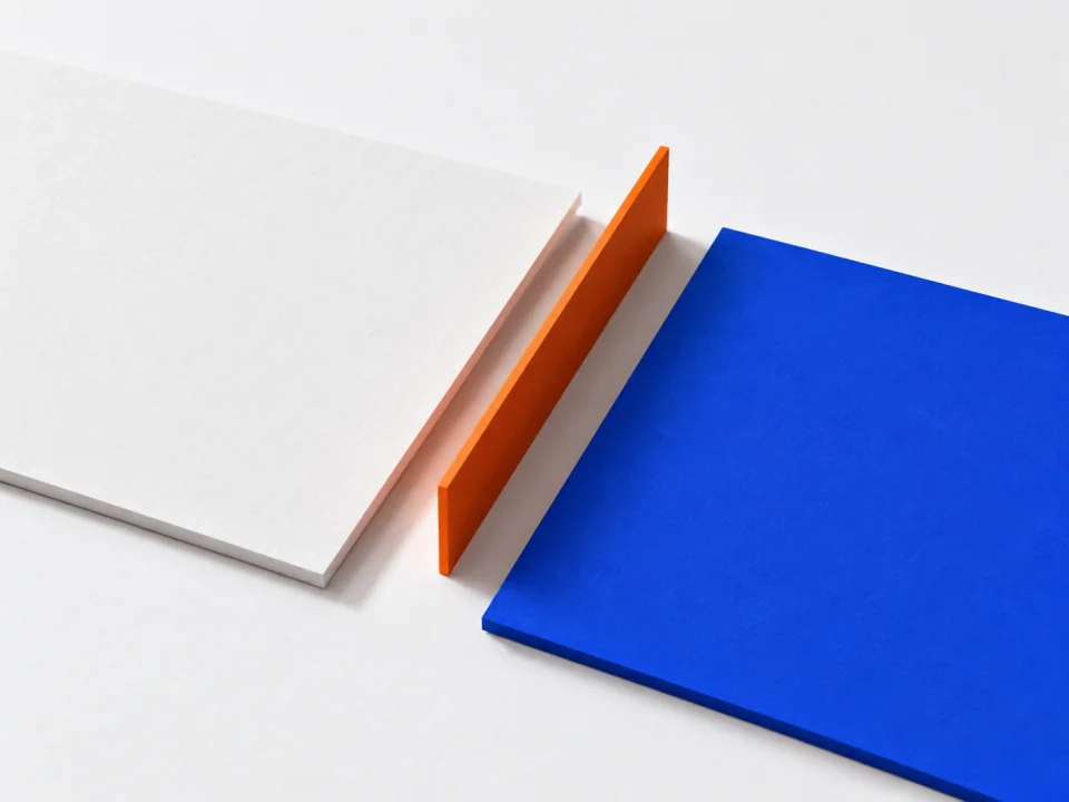 A white sheet and a cobalt sheet separated by a thin upright orange strip.